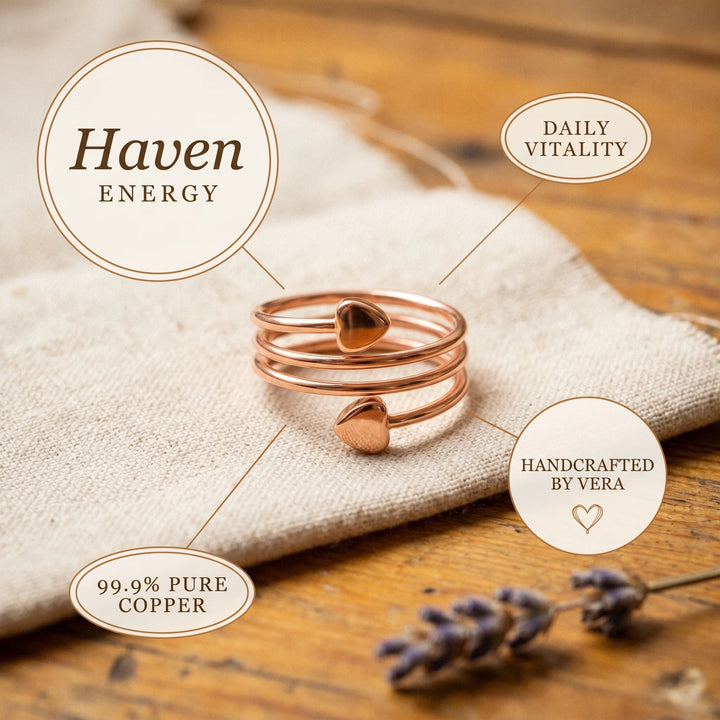 Copper spiral ring positioned on wooden surface demonstrating adjustable open-back construction