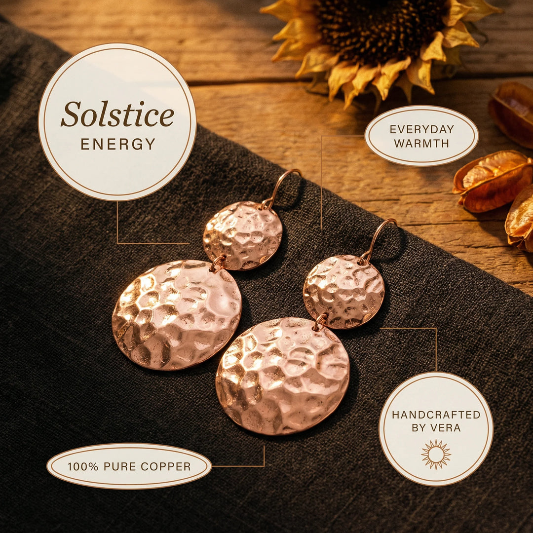 Detail shot of hammered texture on circular copper disc earrings with warm rose gold metallic tone