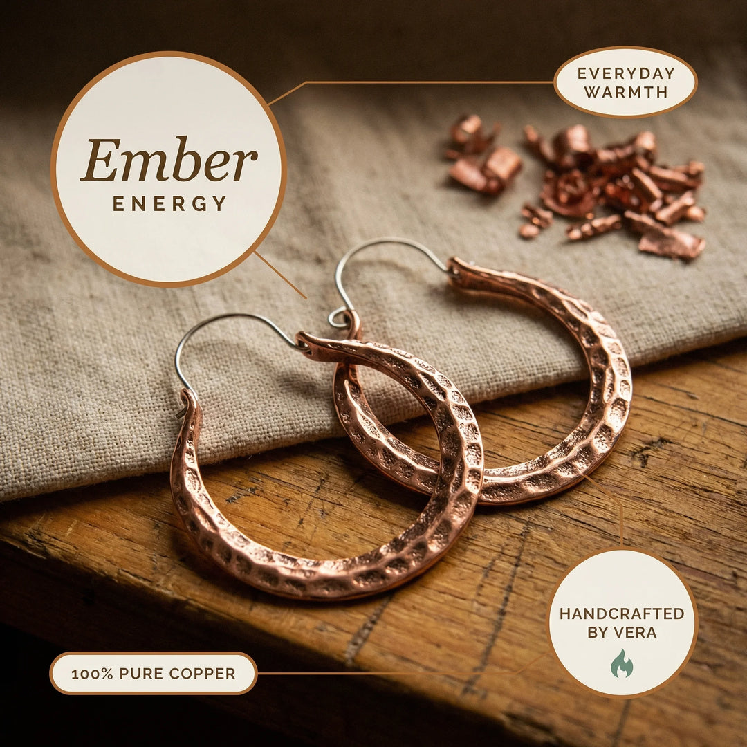 Textured copper hoop earrings in warm rose tone showing crafted metalwork detail