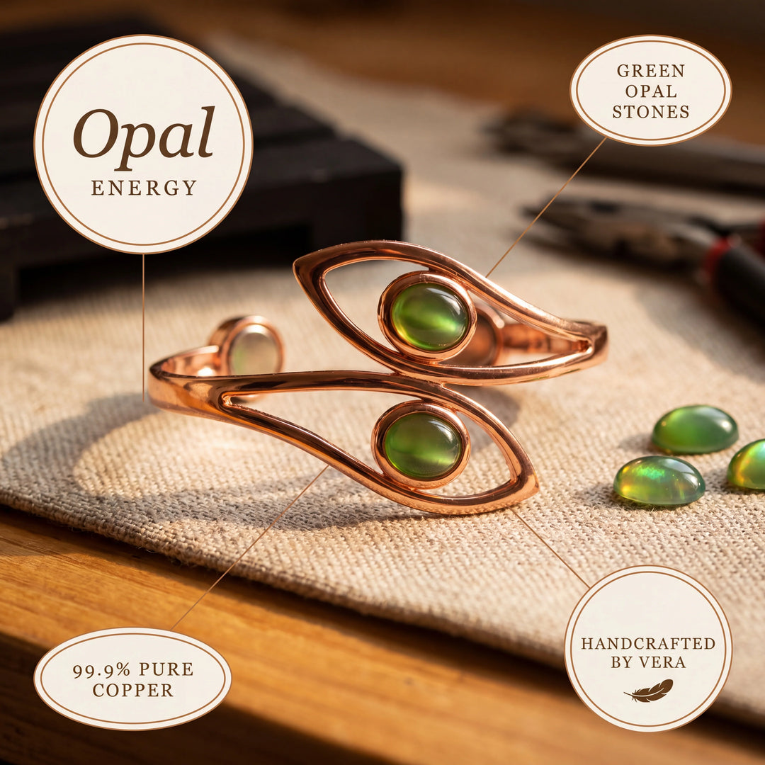 Copper cuff bracelet with smooth finish and green stone accents on natural linen fabric