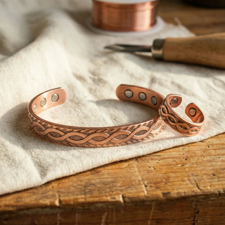 Copper bracelet and ring set with engraved Celtic knot pattern displayed on linen fabric