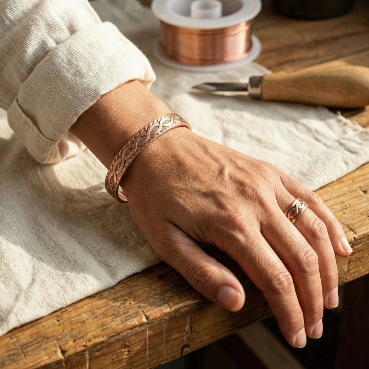 Close-up view of copper cuff bracelet showing intricate interlaced Celtic knot engraving detail
