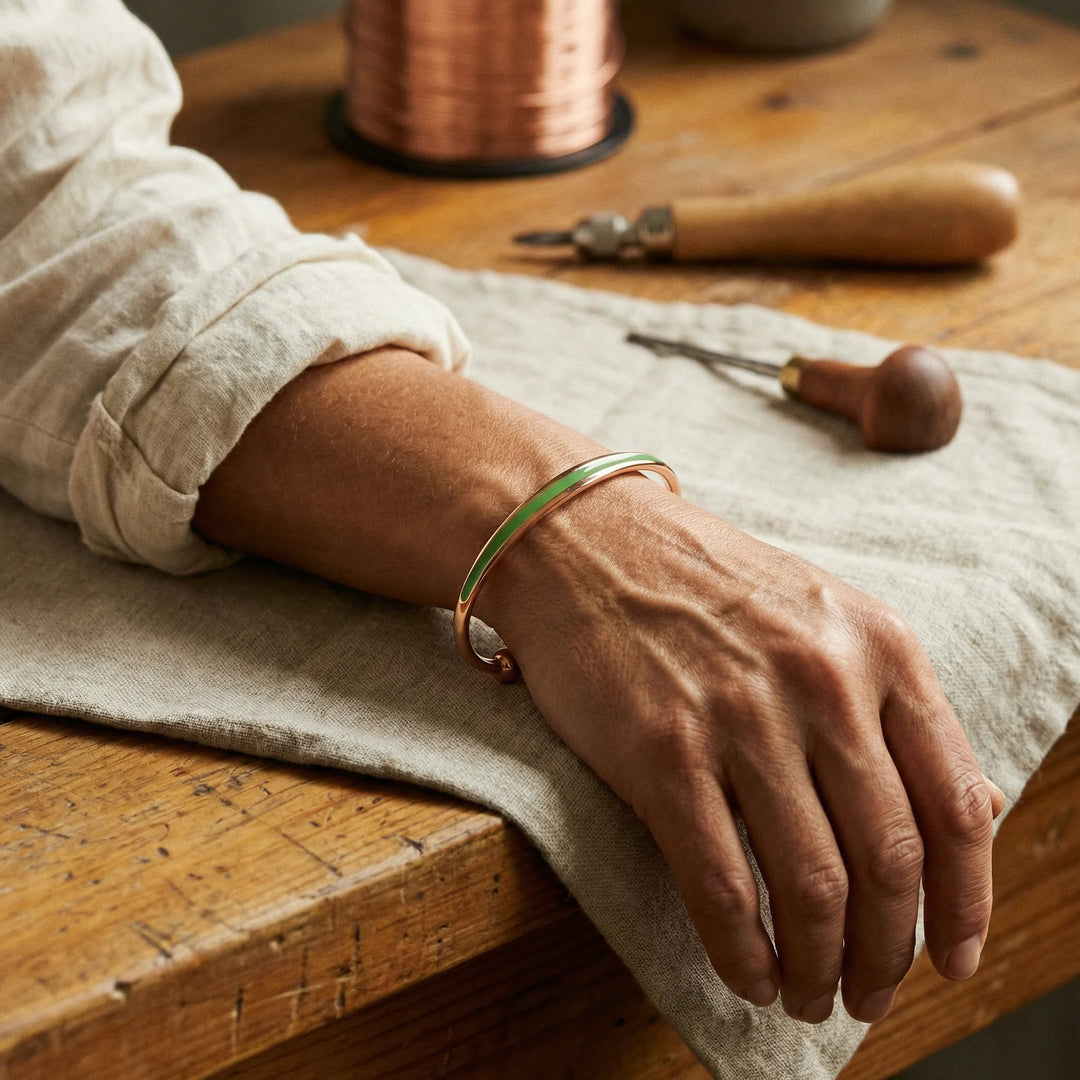 Close-up view of copper cuff bracelet showing jade inlay detail and polished finish