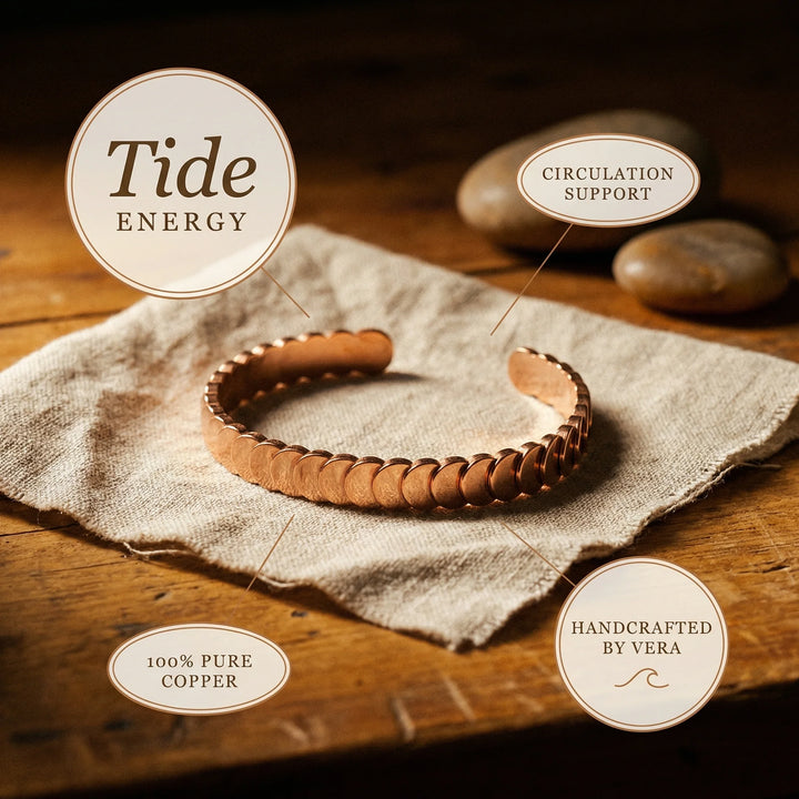 Women's adjustable copper bangle with sculptural scale design on rustic wooden surface
