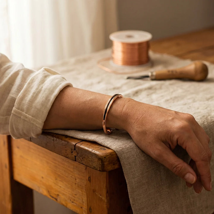 Adjustable copper cuff bracelet with smooth rose-gold finish and minimalist design detail