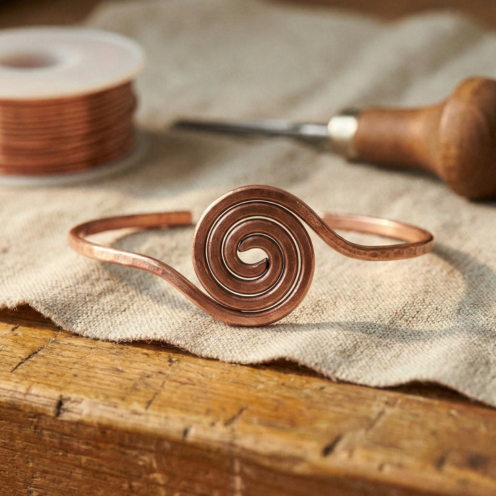 Close-up view of copper spiral anklet showing hand-formed coil centrepiece design