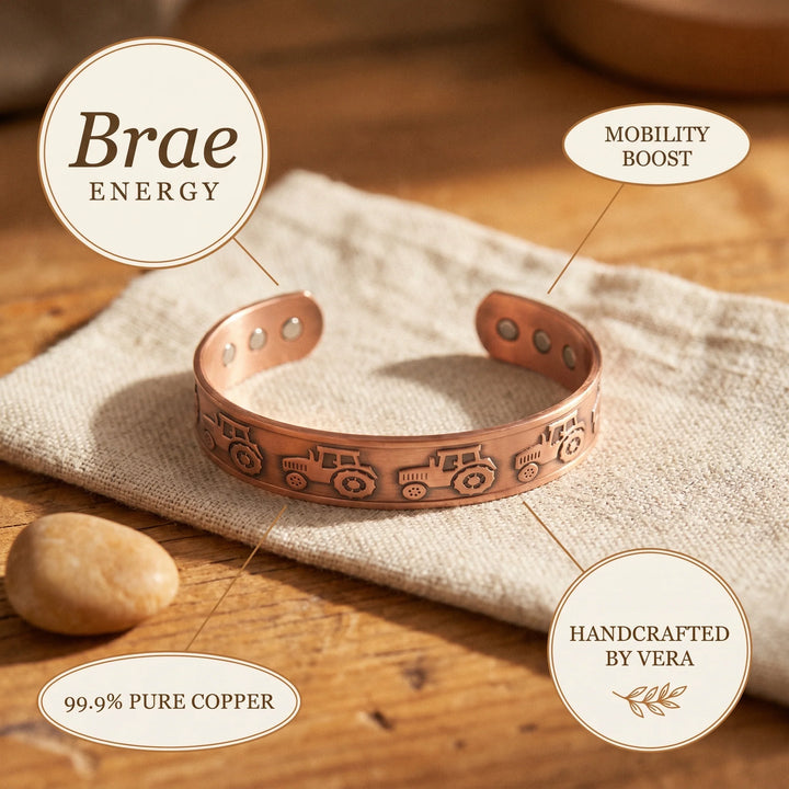 Handcrafted copper cuff bracelet featuring embossed tractor design and adjustable fit on linen